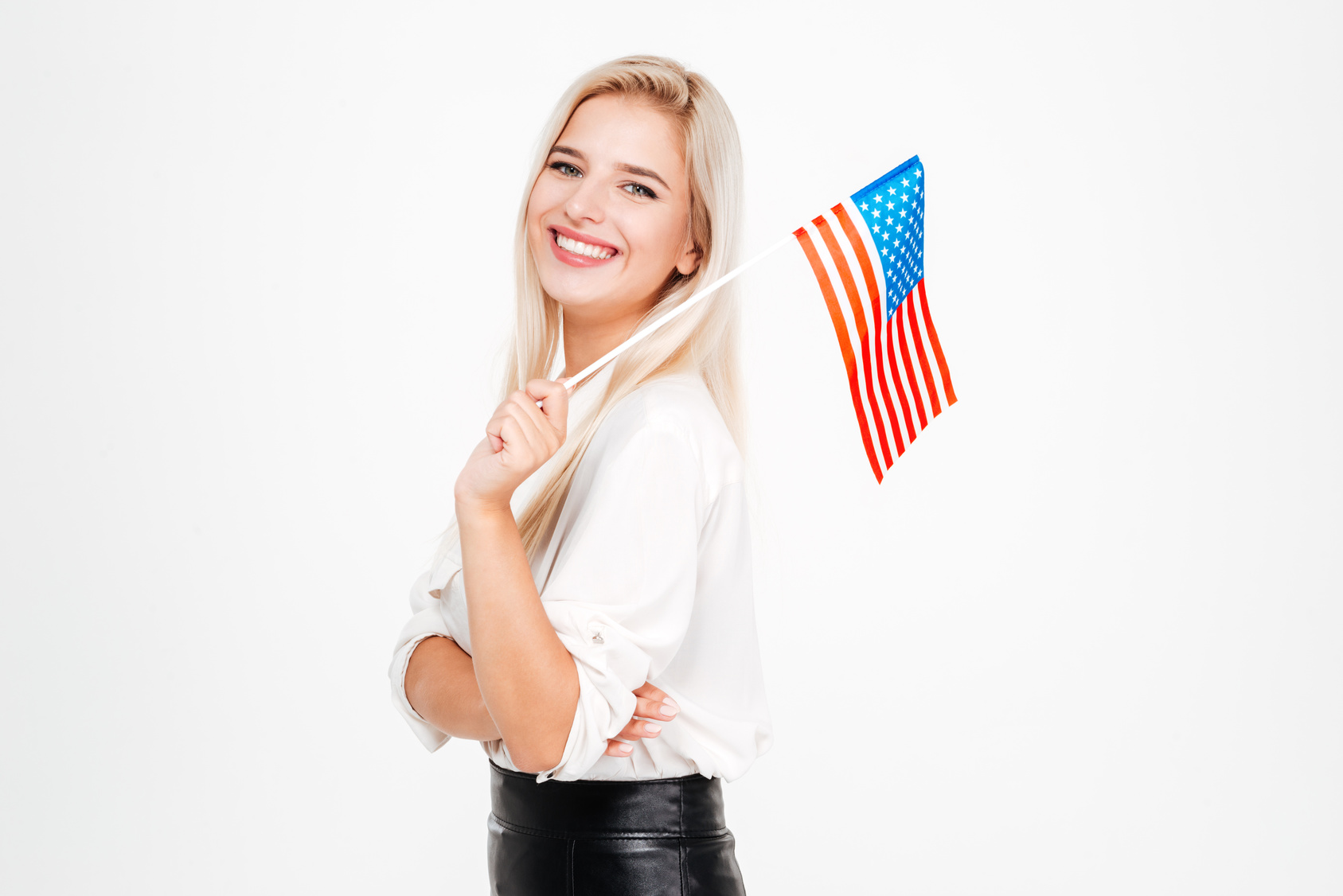 Portrait of happy young businesswoman with flag of America over white background