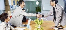 young asian business people shaking hands smiling before meeting or negotiation